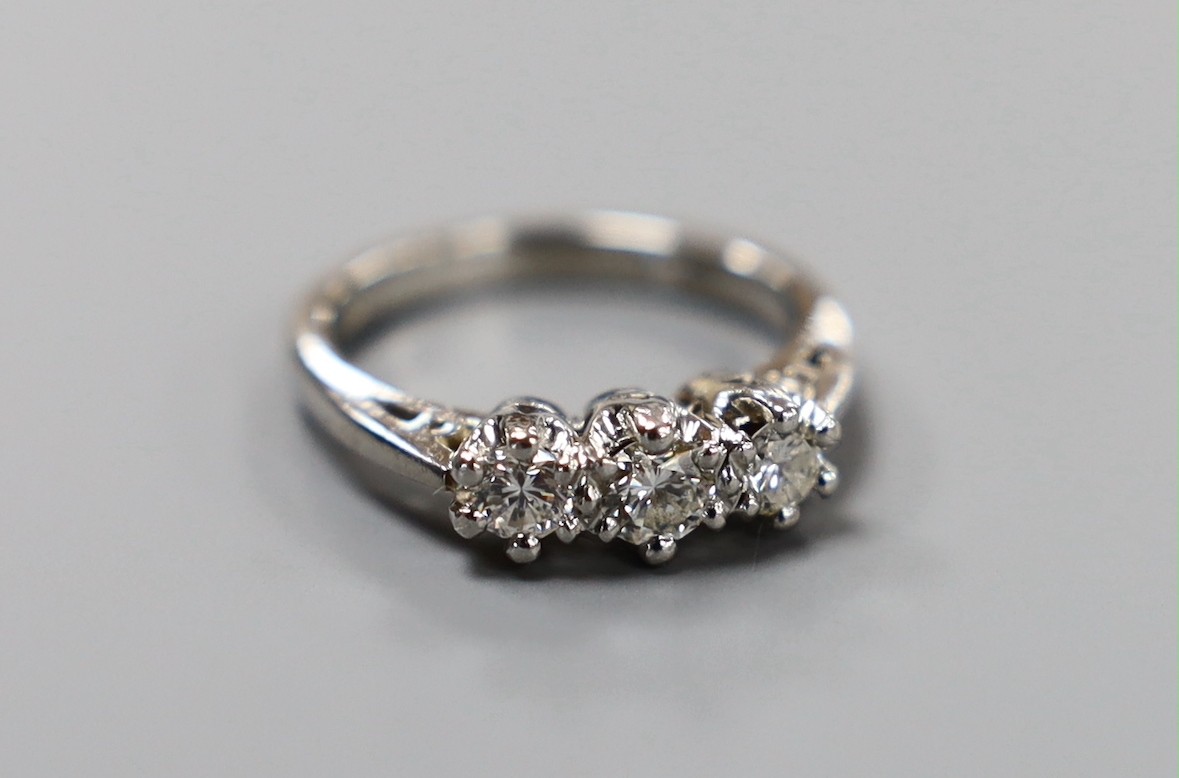 A modern platinum and three stone diamond ring, size H, gross weight 4.8 grams.